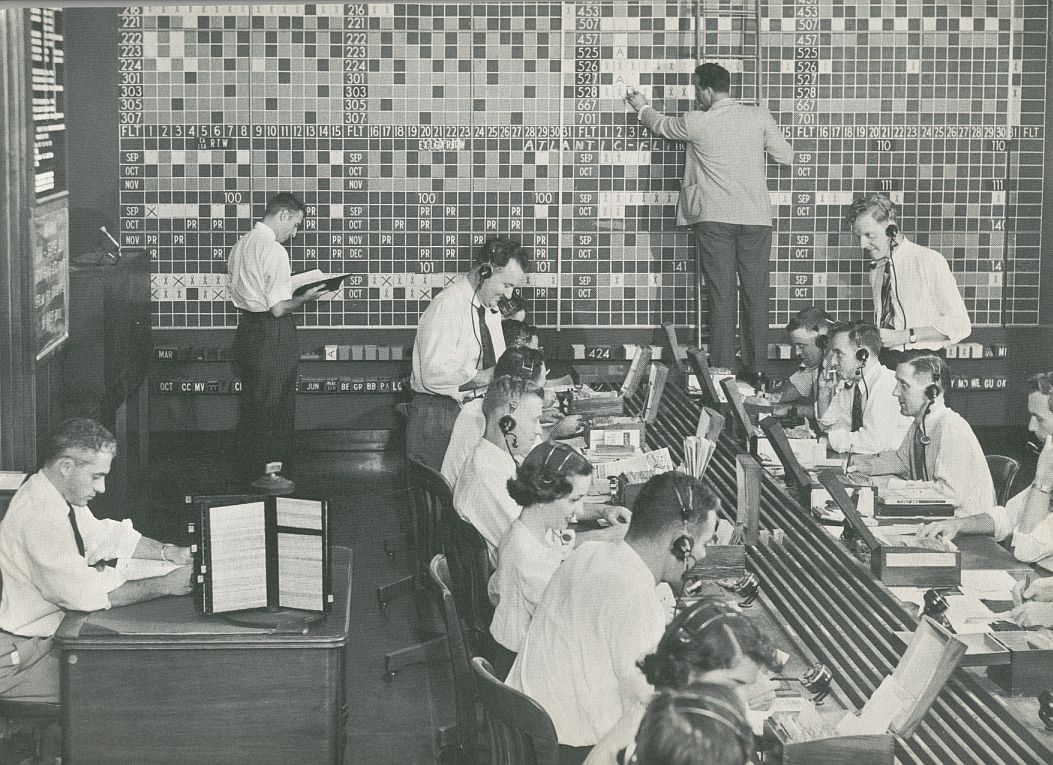 1956 Prior to computers Pan Am reservations agents sent request cards to a big board where booking levels were tracked.